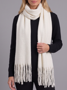 Woman wearing white tassel wrap scarf