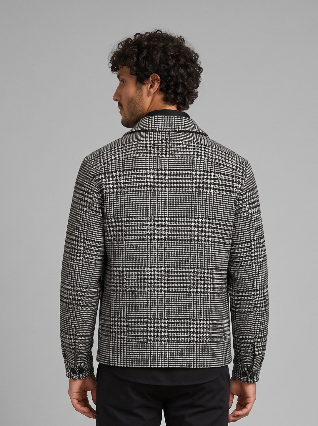Man wearing grey houndstooth check wool-blend overshirt jacket with flap chest pockets, front view