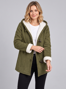 Woman wearing an olive green hooded duffle coat with sherpa lining and toggles