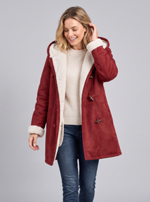 Woman walking in an open red hooded duffle coat with cream sherpa lining