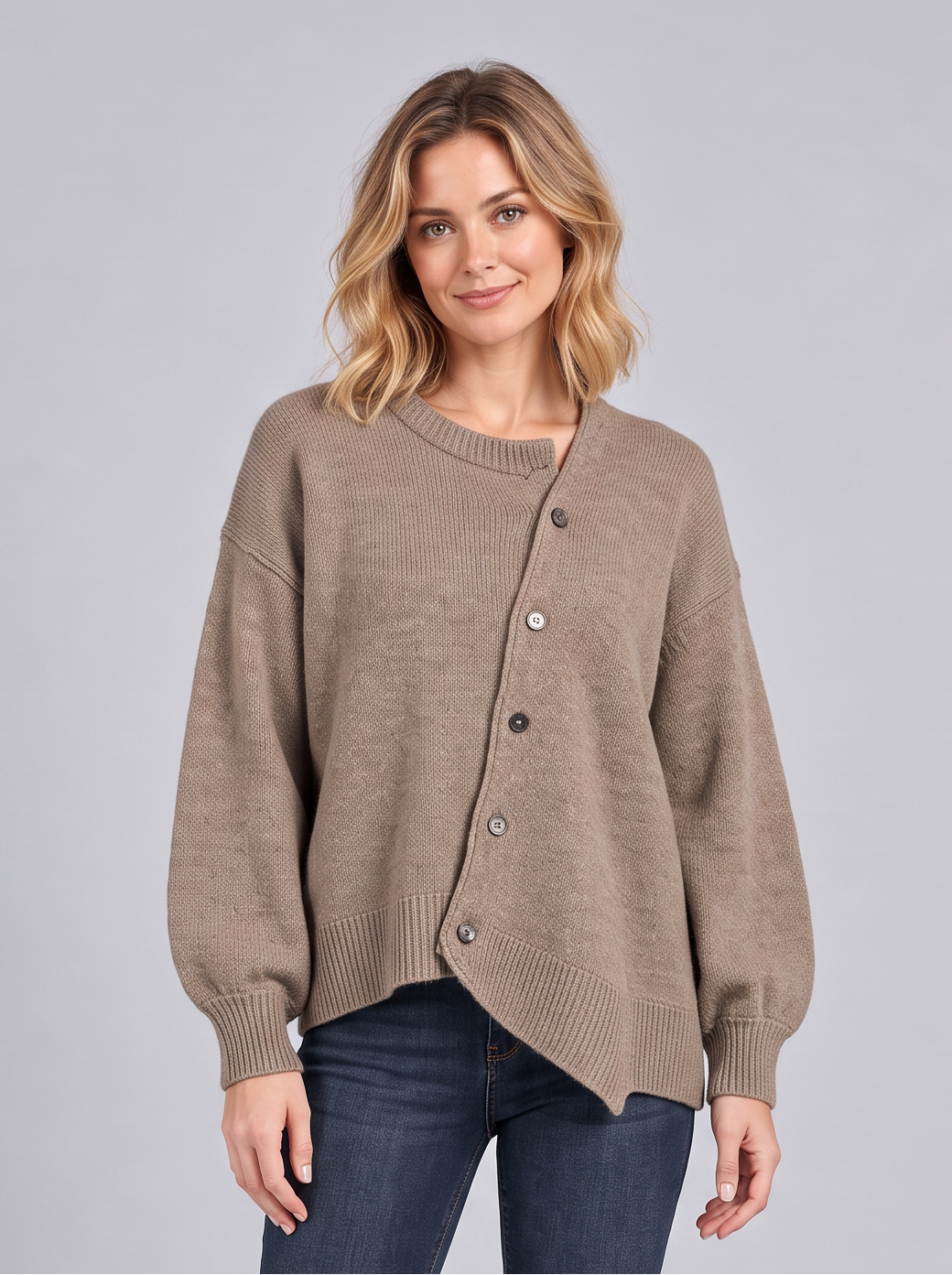 Woman wearing a brown cashmere knit jumper with asymmetric diagonal button front and balloon sleeves, front view