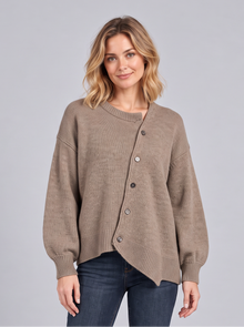 Woman wearing a brown cashmere knit jumper with asymmetric diagonal button front and balloon sleeves, front view