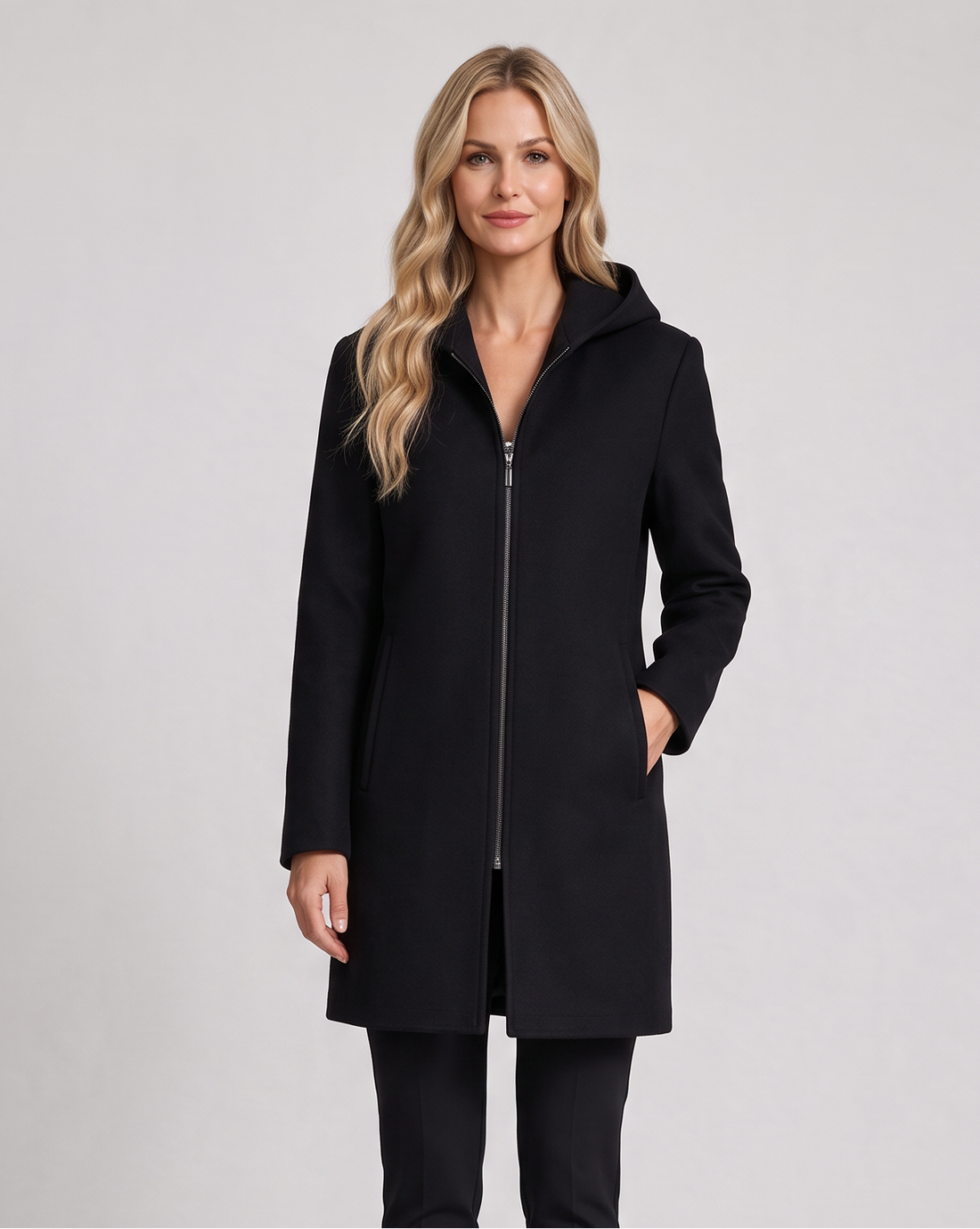 Women's black pure wool hooded full-zip coat worn with black trousers and ankle boots