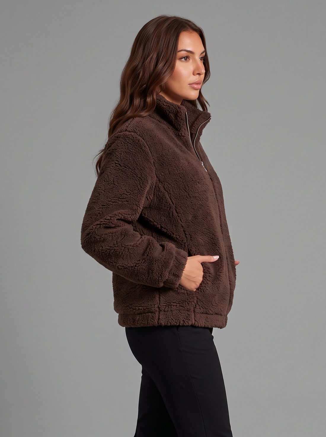 Side view of a dark brown teddy fleece zip jacket with snow boots