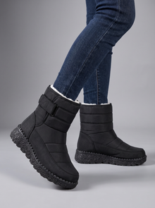 Black quilted snow boots with velcro strap