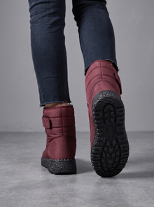 Back view of burgundy quilted snow boots with grip sole