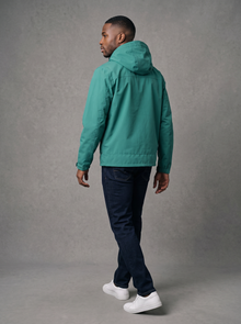 Back view of a jade green hooded rain jacket with hood up