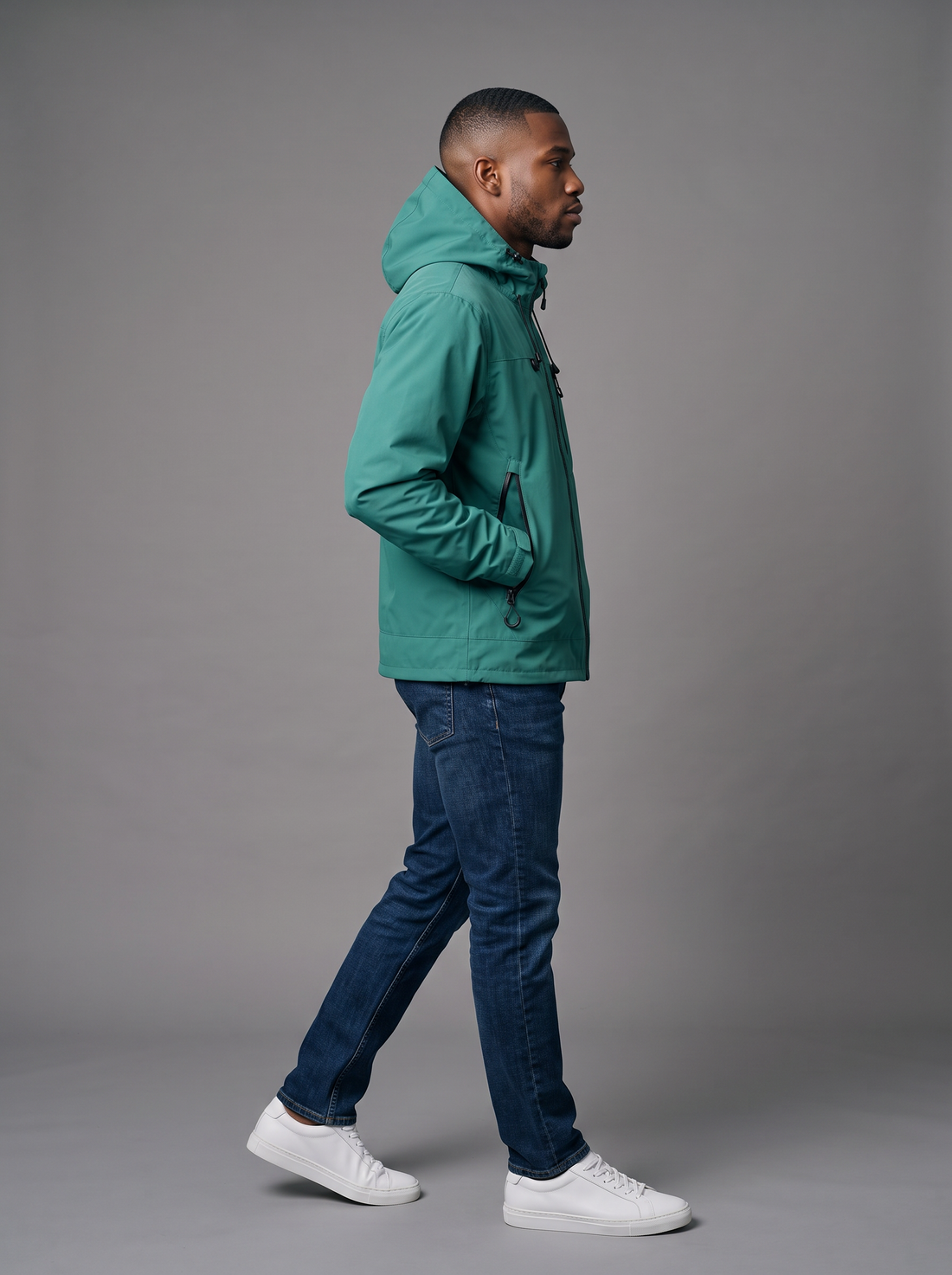 Side view of a jade green hooded windbreaker