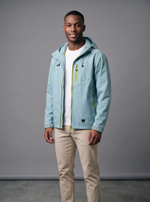 Sky blue hooded rain jacket with beige chinos