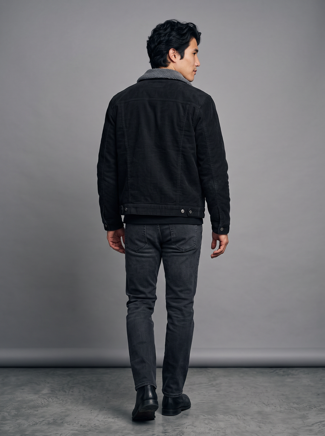 Man wearing a black corduroy jacket with sherpa collar, front view