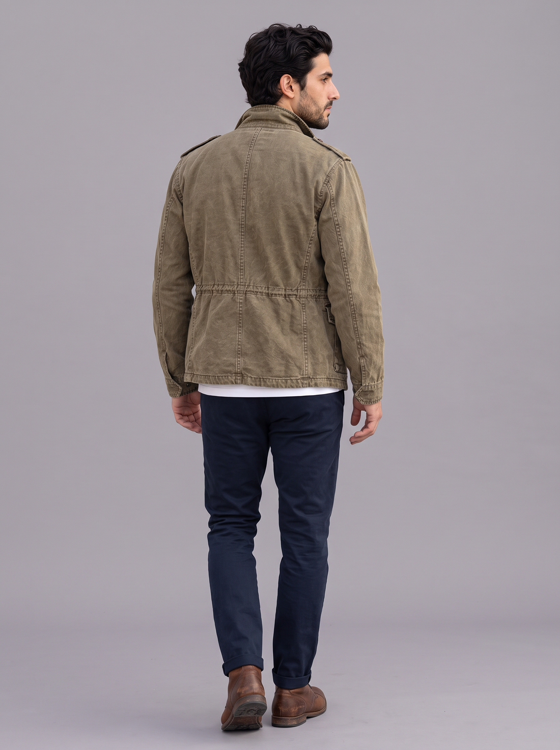 Man wearing an army green cotton field jacket open over a white t-shirt, front view