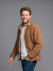Man walking in a caramel sherpa fleece jacket, side view
