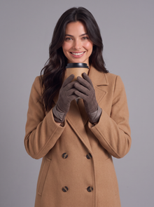 Woman holding a coffee cup in mocha fleece-lined winter gloves