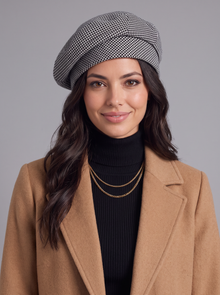 Woman wearing a black and white houndstooth knitted beret