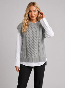 Woman wearing grey cable knit round neck sweater vest