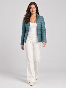 Women’s blue slim-fit puffer jacket, walking studio pose