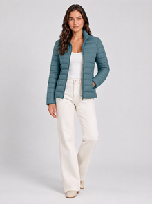 Women’s blue lightweight puffer jacket, three-quarter studio view